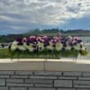 Long floral centerpiece with white and purple blooms on a metal stand
