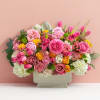 Pink and yellow mixed flower arrangement in a rectangular vase