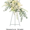 White floral standing spray on an easel