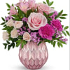 Pink roses and alstroemeria in a pink glass vase