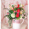 Pink and red rose bouquet in a white pitcher vase
