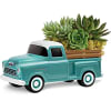 Turquoise toy pickup truck holding a succulent planter
