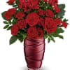 Red roses and alstroemeria in a red glass vase