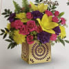 Bright mixed bouquet in a decorative square box with a "celebrate" topper.