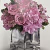 Pink roses and alstroemeria in a clear square vase