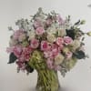 Pink and white rose bouquet in a clear glass vase