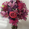 Pink and red bouquet of roses and lilies in a clear glass vase