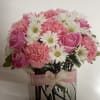 Pink roses and carnations with white daisies in a clear glass vase