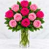 Bouquet of pink and hot pink roses in a clear glass vase