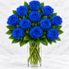 Bouquet of vivid blue roses in a clear glass vase
