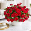 Large bouquet of red roses in a white textured vase