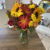 A beautiful array of fall colored flowers accented with sunflowers! 