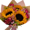 Hand wrapped sunflower arranged in wrapping paper with a colorful mix of