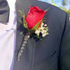 A set of  matching Boutonniere and Bouquet created with red roses