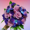Bouquet of lavender roses with purple flowers and blue orchids