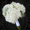 White bridal bouquet with hydrangeas and roses wrapped in white ribbon