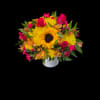 Bouquet of yellow sunflowers and pink flowers in a white vase