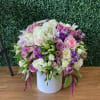 Large pastel flower arrangement in a white vase