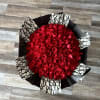 Large bouquet of red roses wrapped in black and white paper