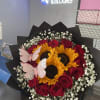 Bouquet of red roses and sunflowers with pink butterfly decorations