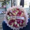 Pink and white rose bouquet with a Happy Birthday ribbon