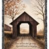 Fringed throw blanket with a covered bridge scene and memorial quote