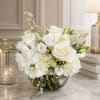 White floral arrangement in a clear glass bowl vase