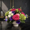 Colorful flower arrangement in a white pedestal bowl