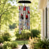 Floral-patterned metal wind chime hanging outdoors