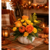 Orange and yellow roses in a white pumpkin vase with fall accents