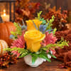 Yellow roses and pink flowers arranged in a white vase