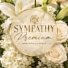 White sympathy floral arrangement with roses, lilies, and hydrangeas