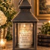 Memorial lantern with a candle and white hydrangeas beside it