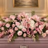 Pink and white floral arrangement with roses, lilies, and carnations