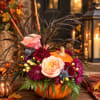 Pumpkin arrangement with pink roses and burgundy flowers