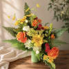 Vibrant orange roses and sunny yellow daisies create an immediate burst of