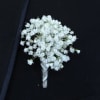 White baby's breath boutonniere on a dark suit