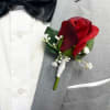 Red rose boutonniere on a gray suit jacket