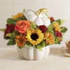 Pumpkin-shaped vase with orange, yellow, and red flowers