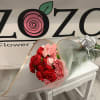 Bouquet of red and pink carnations wrapped in translucent paper