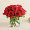 Red roses arranged in a clear glass vase