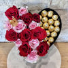 Heart-shaped box with red and pink roses and gold-wrapped chocolates