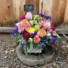 Colorful mixed bouquet in a white box with roses and alstroemeria