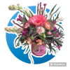 Bright pink and peach mixed flower arrangement in a pink jar-style vase