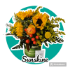 Sunflower bouquet with orange ranunculus in a green striped container