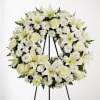 White floral wreath on a black easel