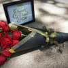 Bouquet of red roses wrapped in black paper with gold ribbon