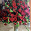 Large red and pink rose arrangement in a tall vase