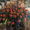 Large floral spray with red roses and blue accents