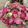 Pink ranunculus bouquet in a round pink box